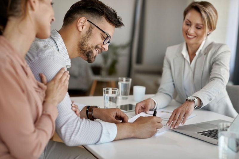 Business buyer signing paperwork with business broker